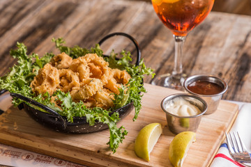 fried rabas with salad and sauces