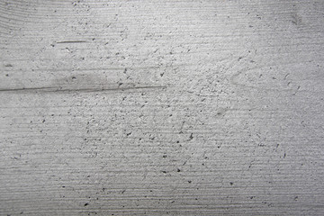 Grainy light grey wood background texture, close-up