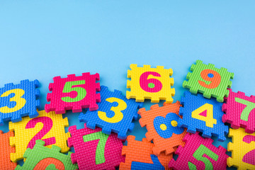 Colorful kids numbers toys on blue background. Education concept. Creative concept. Flat lay, copy space, top view.