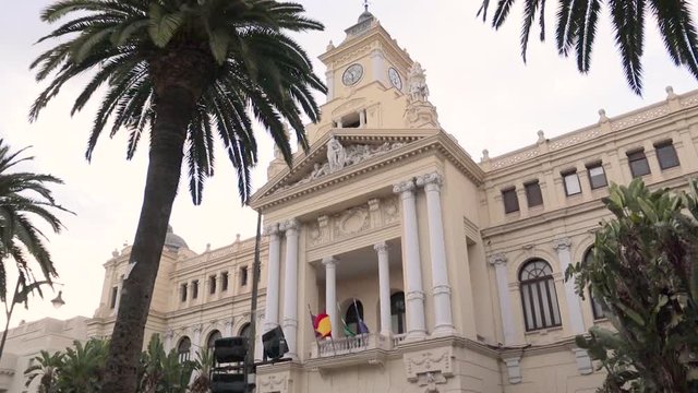 Beautiful Malaga Town Hall. Opened in 1919 is the work of the architects Guerrero Strachan and Rivera Vera. It has a neobaroque style. Cloudy day. Tilt Down