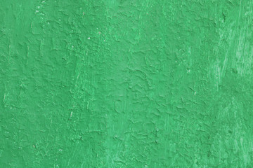 Beautiful vintage green background with old green paint with a rough surface, streaks and uneven texture of green paint on an old rough surface