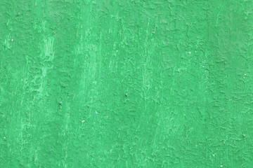 Beautiful vintage green background with old green paint with a rough surface, streaks and uneven texture of green paint on an old rough surface