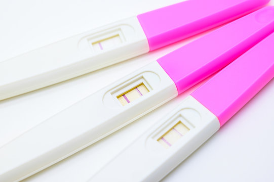 Positive ovulation test against white background focused on center of image