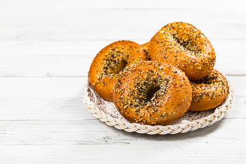 Freshly Baked Bagels Topped with Sesame Seeds, Poppyseeds, Garlic and Onion. Selective focus.