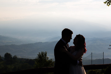 Beautiful wedding couple posing outdoor on sunset