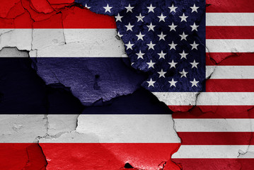 flags of Thailand and USA painted on cracked wall