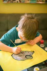 Beautiful creative boy is creativity and the artist in an online drawing  paints lesson. Childrens creativity. The concept of distance learning online school for the period of global quarantine.  © Iryna