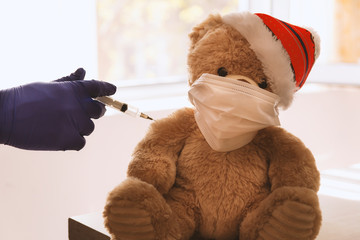 teddy bear with surgical mask and syringe