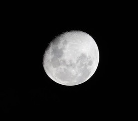 Bright moon highlighting the deep craters taken over Sydney NSW Australia on a dark cloudy night 