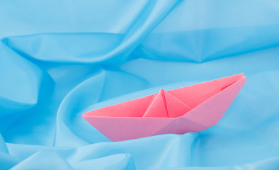 paper boat on a blue background