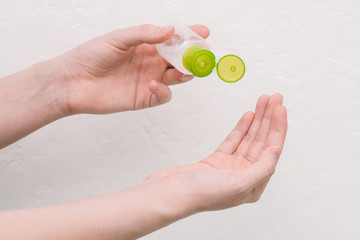 A woman squeezes an antibacterial disinfectant on her hands. Scrubbing hands from germs, bacteria, and other infections. Coronavirus Prevention.