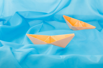 paper boats on a blue background