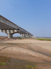 Fototapeta na wymiar A wideangle view of a bridge under construction on a river
