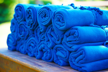 A set of warm blue rugs at an open-air party, in case guests feel cold in the evening