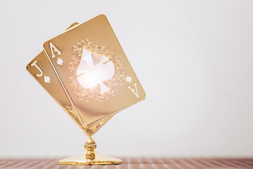 statuette made of gold in the form of playing cards with a diamond inside. The concept of success.