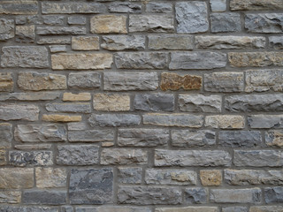 Traditional local stone house wall in Street, Somerset, England. Maybe blue lias. Old.