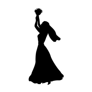 Silhouette bride throws bouquet of flowers
