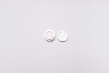 Moisturizer cream jar on grey white background. Flat lay, top view, copy space. Natural organic product