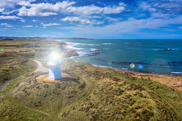 Waipapa Point Lighthouse, surrounded with golden beaches and snoozing sea lions