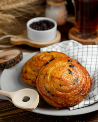 sweet roll with raisins on a white plate
