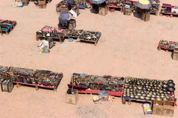 Nepal, Kathmandu, 09.10.2018. Square with souvenir shops, the seller sits under an umbrella hiding...