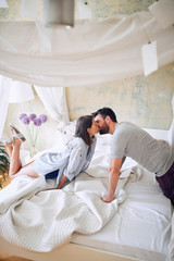 Beautiful morning in bed.Man i woman in love kissing at bed. © luckybusiness