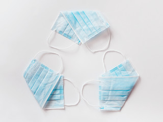Reuse - reusable surgical mask folded in the form of a sign and a recycling symbol - material...