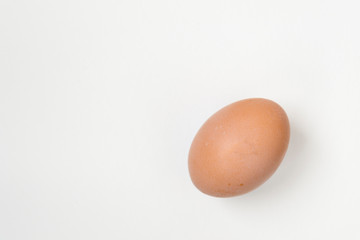 Close up of an egg lying on a white background. There is a place for text. Easter concep.