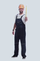 in full growth. man Builder with construction tape measure