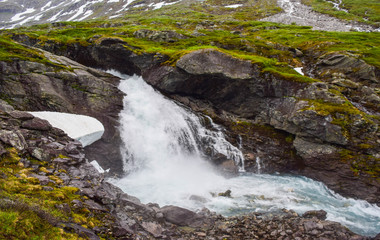 Naklejka na ściany i meble Waterfall and river with clear water. Jostedalsbreen National Park. Norway.