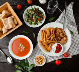 tomato soup, vegetable salad and chicken with french fries
