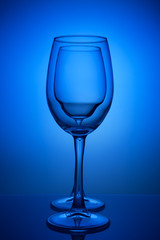 wine glass inside a wine glass on a blue background