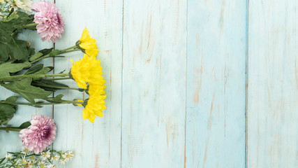 Flowers on wooden background with copy space