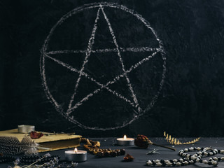 Mystical still life with books on ancient magic, pentagram, candles and symbols