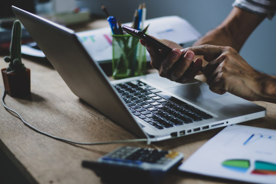 Asian Man Working From Hone Online Because Of Covid-19. Work At Home And Social Distancing Concept. Selective Focus.