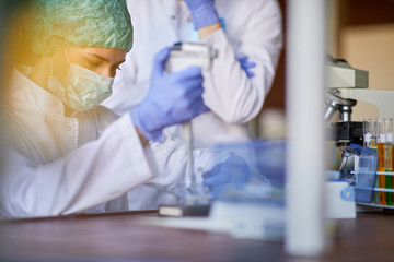 Lab technician examining blood sample on corona virus