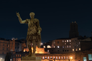 Fototapeta na wymiar Statue of Trajan,Imperial Forums,Rome. Roman Emperor born in Spain. Famous for reforms, construction work on aqueducts and ports. He telling his story on the Trajan column in the Trajan markets.