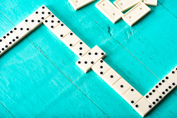 Playing dominoes on a blue wooden table
