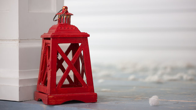 red wooden candle latern