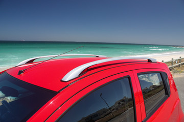 Fototapeta na wymiar Red car near the beach