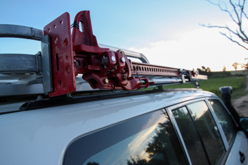 Rugged 4x4 with roof-mounted jack © hanjosan