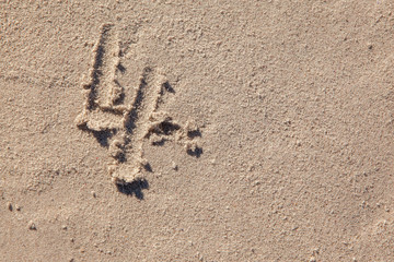 4 written on beach sand