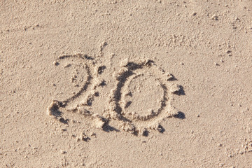 20 written on beach sand