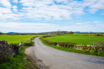 Mother and choildren walk on country rural road in Cumbria