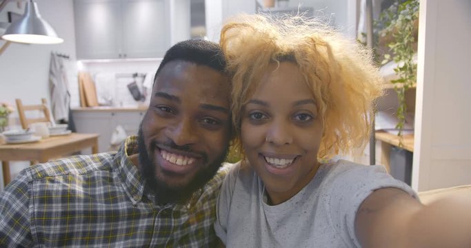 Pov shot of african couple taking selfie in kitchen
