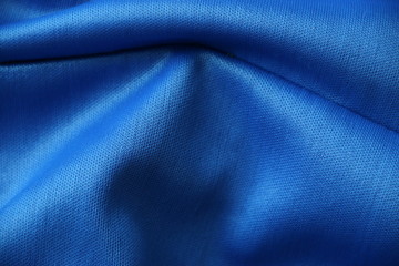 fondo azul textil con reflejos de luz blanca