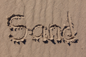 sand written on beach sand
