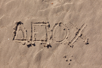 playstation symbols written in beach sand