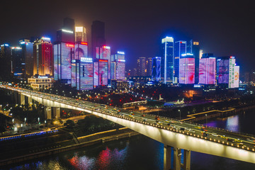 Fototapeta na wymiar Aerial view of Huang Hua Yuan bridge over Jialing river in the night with lighted building