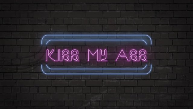Bright neon sign on a brick wall with the rude and vulgar text "Kiss my ass"